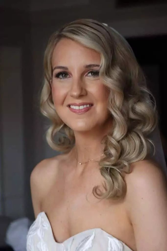 Bride wearing soft glam makeup and Hollywood waves capturing the timeless allure of Hollywood glamour.